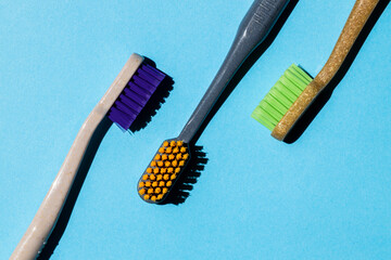 three different toothbrushes on a blue background