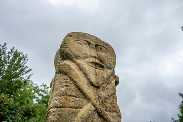 Fototapeta na wymiar This is a bronze age stone carviing with two faces,called Janus, located In Caldragh Cemetery on Boa Island, Lower Lough Erne. Northern Ireland