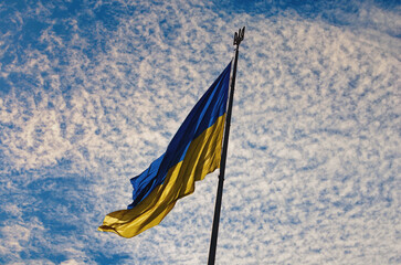 The Biggest National flag Ukraine against blue sky with fantastic soft clouds. Blue and yellow flag of Ukraine. Waving Ukrainian flag. Landscape orientation - Powered by Adobe