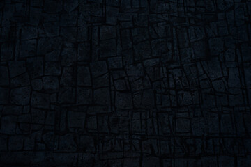 Black blue background with space for design. Toned rough surface of an old stone wall. Dark blue color. Backdrop. Solid. Grunge.