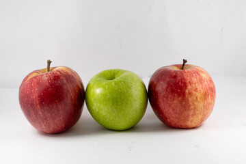 Red fuji apple and green granny smith apple on white background.