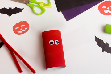 Step by step photo instruction Halloween craft. Step 2 Handmade decoration monster from toilet paper roll. Reuse concept