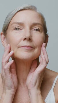 A senior age model without makeup posing looking at the camera