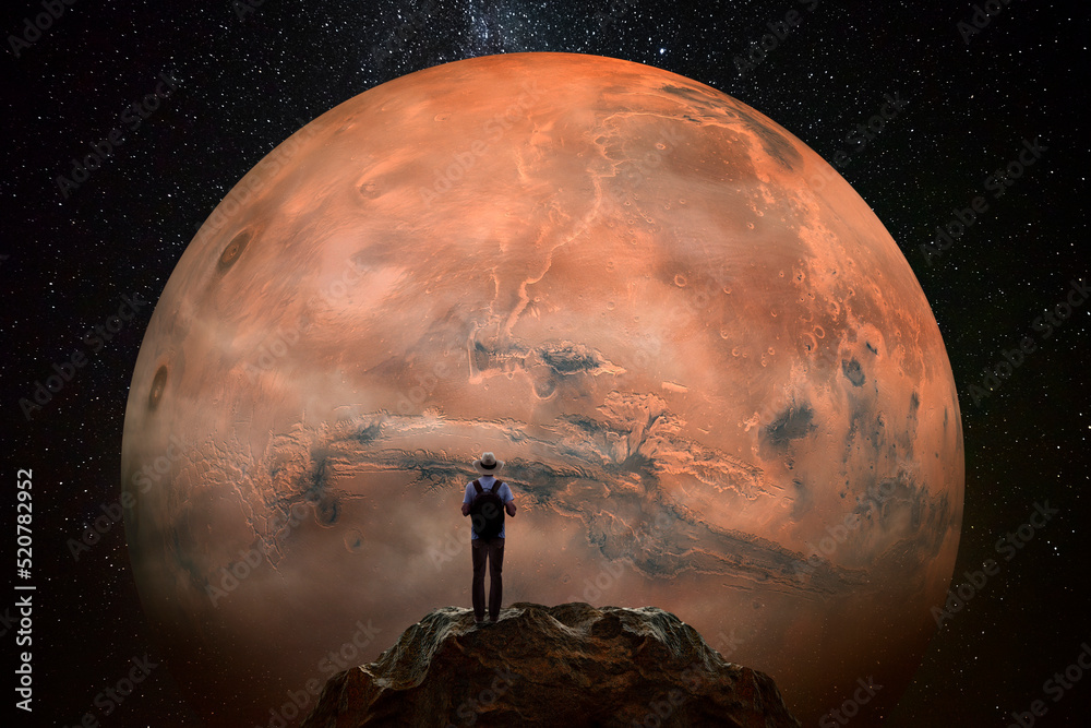 Canvas Prints man observing the mars planet from top of mountain