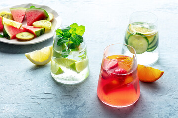 Fresh summer cocktails or mocktails with fruit and ice, a vacation party with watermelon, strawberry, citrus and cucumber lemonades