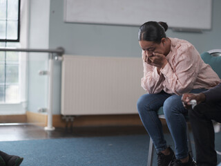 Woman crying in group therapy session