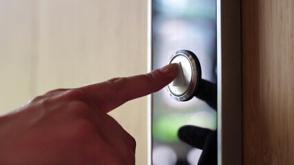 Close-up view on female hand pushing elevator lift button in business center. © Stock 4 You