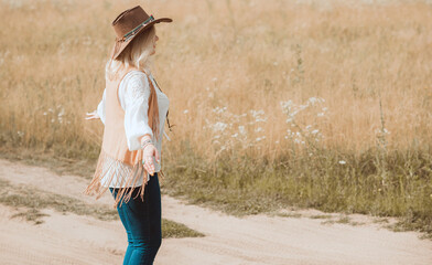 Woman Plus size in American country style black boho jacket, with a fringe, shirt and cowboy hat at nature © T.Den_Team