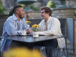 Fototapeta na wymiar UK, South Yorkshire, Gay couple enjoying coffee at cafe table