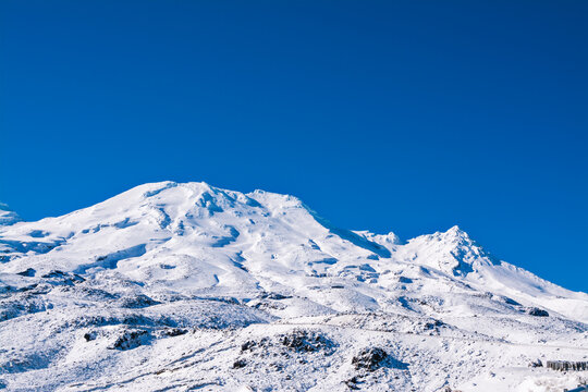 Magnificent peaks of Mountain Ruapehu covered with beautiful winter snow. Tongariro National Park, North Island of New Zealand on a bright sunny day