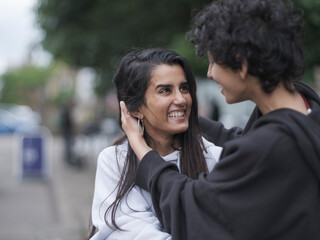 Smiling female couple in city