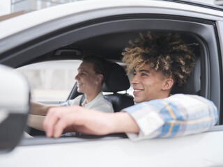 Smiling male couple driving car