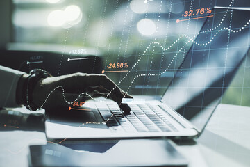 Multi exposure of abstract statistics data hologram interface with hands typing on computer keyboard on background, computing and analytics concept