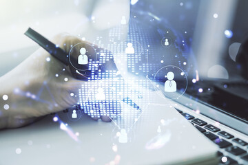 Social network concept with world map and hand writing in notebook on background with laptop. Multiexposure