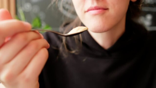 Eating Ice Cream In Cafe. Young Woman With A Spoon Savouring Chocolate Ice Cream From Sundae Glass Cup. Handheld Close Up Shot