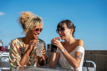 Female couple having dreams in outdoor cafe © Cultura Creative