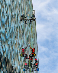 RUSSIA, MOSCOW - JULY 17, 2022: Industrial climbers cleaning windows on the facade of an office...