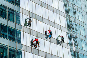 RUSSIA, MOSCOW - JULY 17, 2022: Industrial climbers cleaning windows on the facade of an office...