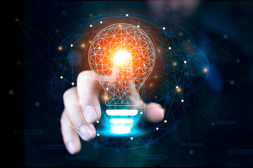 Businessman Touching Icon Bulb.Concept of Ideas for success.Concept with innovation...
