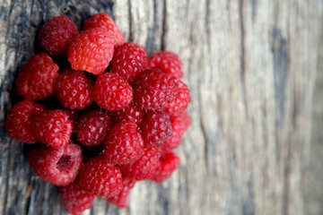 Fresh organic red raspberries. Composition with non-gmo red raspberries on the table. The concept of health, non-gmo products, clean ecological food.
