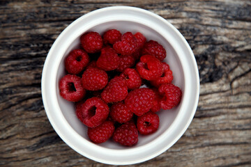 Fresh organic red raspberries. Composition with non-gmo red raspberries on the table. The concept of health, non-gmo products, clean ecological food.