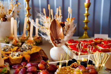 beautiful setting of a table with snacks and dried flowers . catering services. 