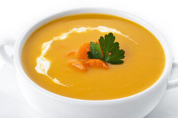 Carrot soup with cream and parsley isolated on white background. Close up