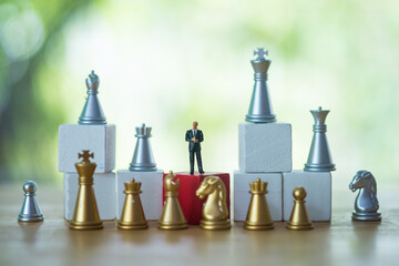 Miniature businessmen or politicians with golden and silver color chess. Business concept