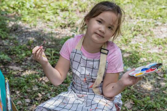 Young Artist Kid Holding Paint Brush And Plastic Palette In The Garden, Kids Artist