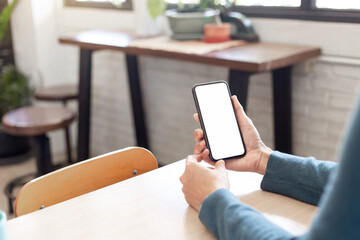 cell phone blank white screen mockup.hand holding texting using mobile on desk at office.background empty space for advertise.work people contact marketing business,technology