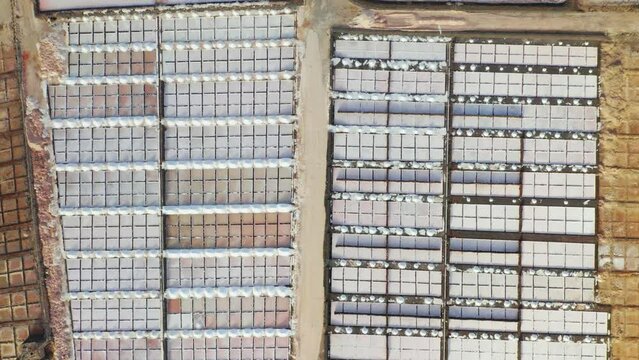 Natural sea salt production site with colorful evaporation ponds pools aerial view from above