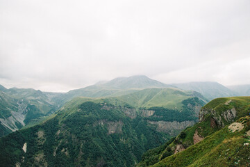 Fototapeta na wymiar View of the green mountain peaks in Georgia. Grainy film in the style of old photos