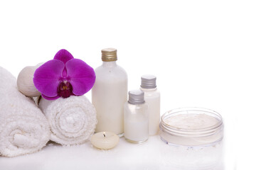 Obraz na płótnie Canvas Spa setting with bottles of essential oil , herbal ,ball, candle , rolled towel, orchid 