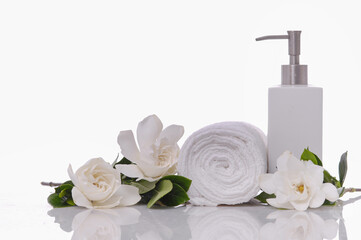 SPA concept with orchid and rolled towel, oil bottle, gardenia jasminoides ,on white background