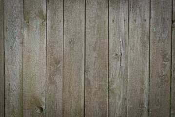 wooden texture from gray boards in the fence wall on the street