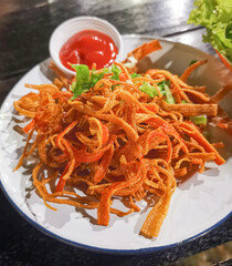 
Crispy crab sticks on a white plate, close up