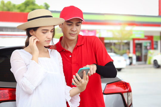 Beautiful Woman Traveler Riding Using Mobile Phone Navigation While Asking Gas Station Attendant Staff For Finding Right Direction, Cute Female Tourist Getting Lost And Confusing In The City, Asking F