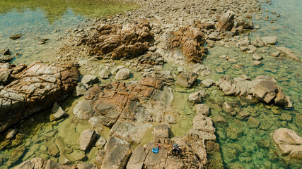 Aerial drone view of rocky coastal scenery at Besar Island or Pulau Besar in Mersing, Johor, Malaysia