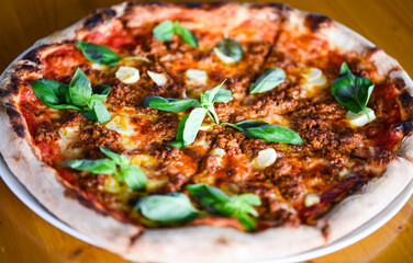 tasty bolognese pizza with fresh basil