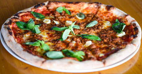 tasty bolognese pizza with fresh basil