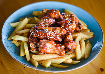 crispy barbecue chicken wings with fries