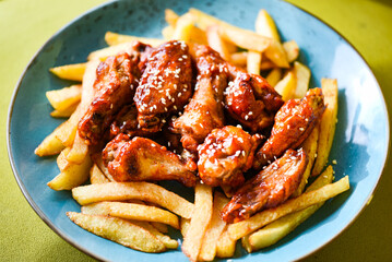 crispy barbecue chicken wings with fries
