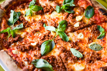 tasty bolognese pizza with fresh basil