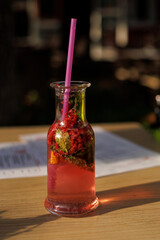 berry tea in a transparent original glass on a table in a cafe