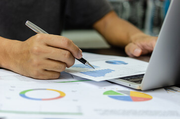 businessman data document graph chart report marketing research development working at office with laptop.