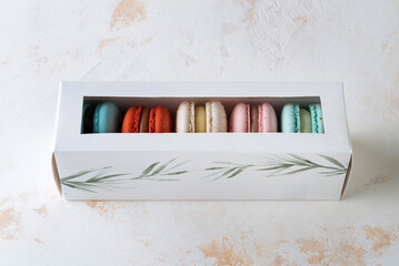 French colorful macarons background, several cakes lie side by side. 45 view