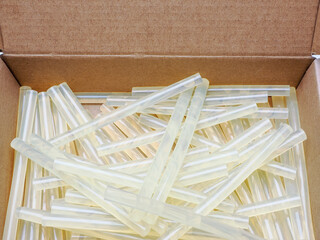 close up of a cardboard box of hot glue gun  rods sticks