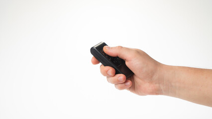 A man's hand holds a bullet control pointing upwards