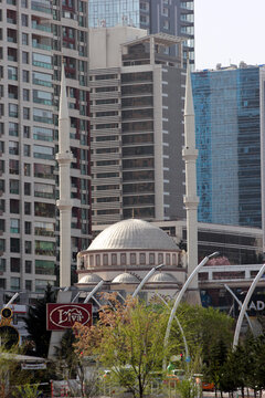 Ankara, Turkey - April 18, 2022: Firdaws Mosque and modern residential buildings in Cankaya Kizilirmak district of Ankara.
