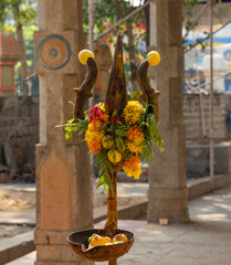 A Worshipful TRISHOOL with lemons and flowers